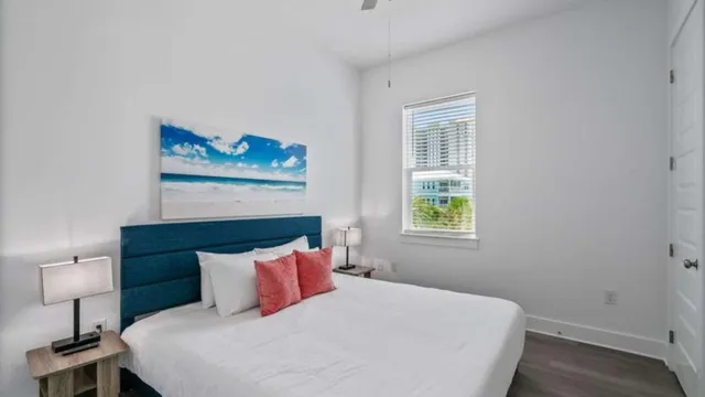 a bedroom with a bed and a painting on the wall