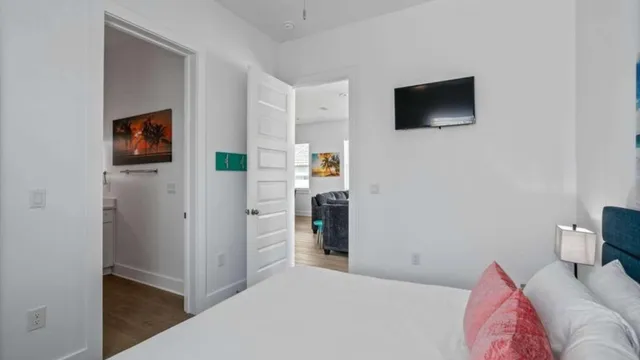 a bedroom with a bed and a flat screen tv