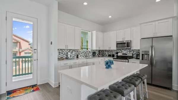 a kitchen with a sink a stove and refrigerator