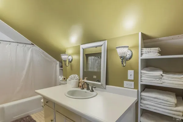 a bedroom with a bed and a dresser next to a window