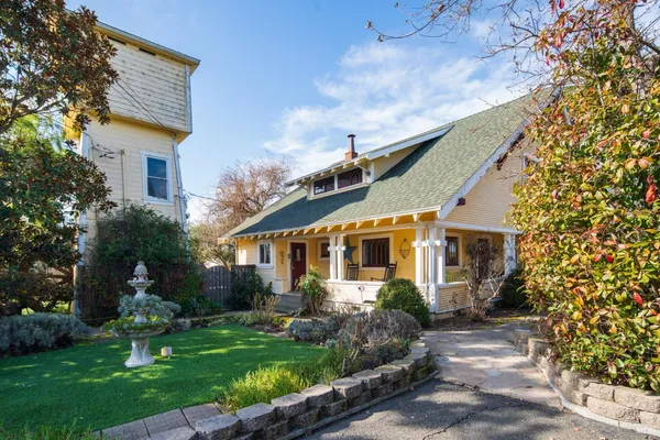 a front view of house with a garden