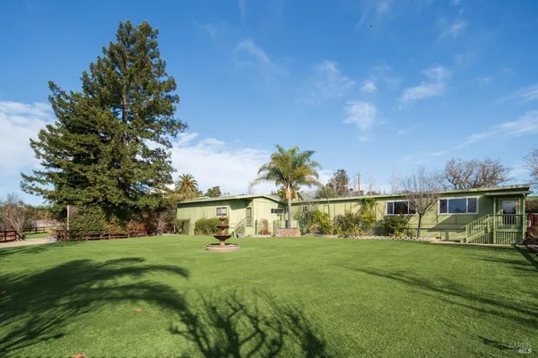 a view of green field with sitting area
