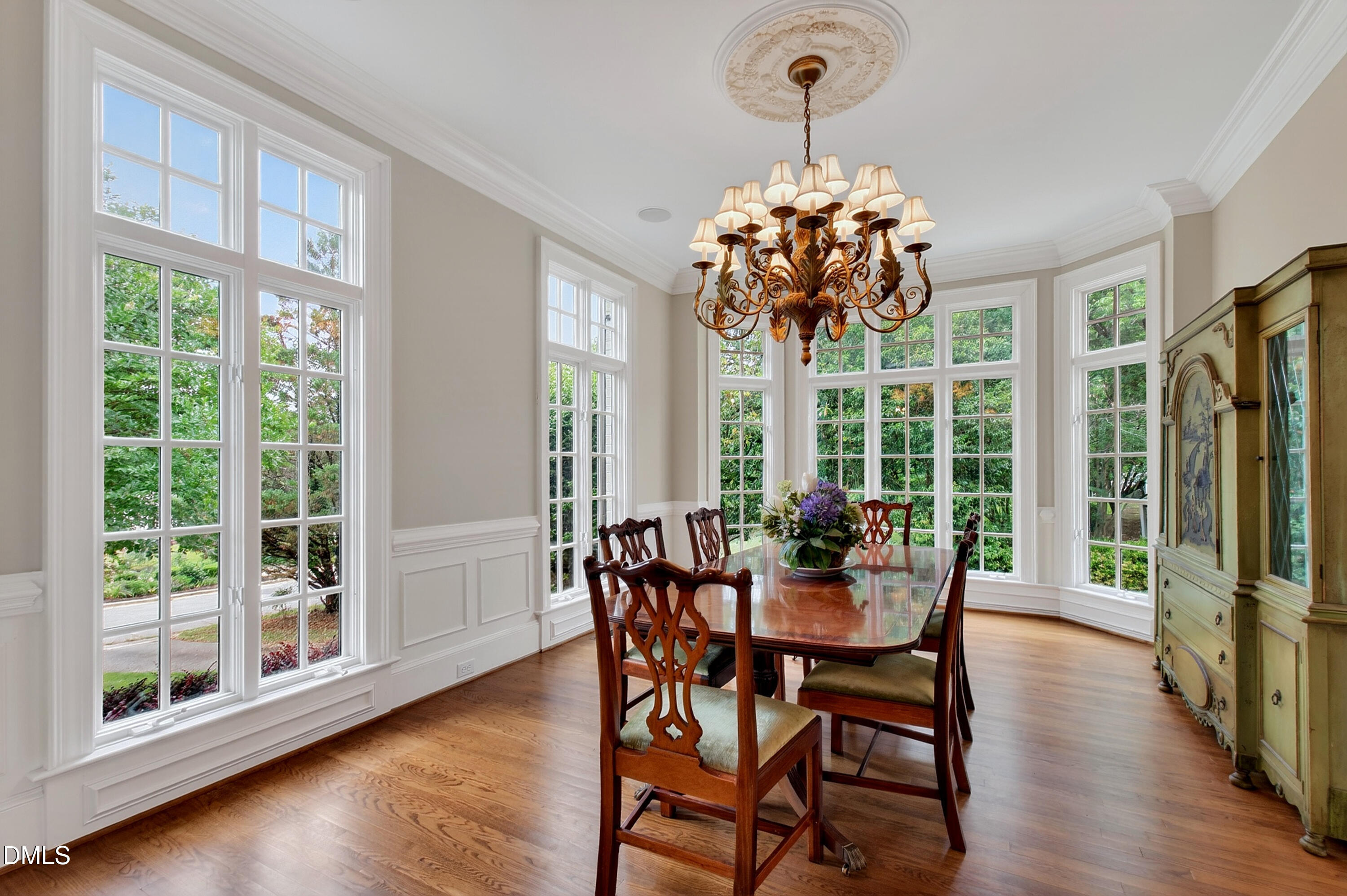 2536 Wake Drive Raleigh, NC 27608 - Photo 9 of 74 a dining room with furniture a chandelier and wooden floor