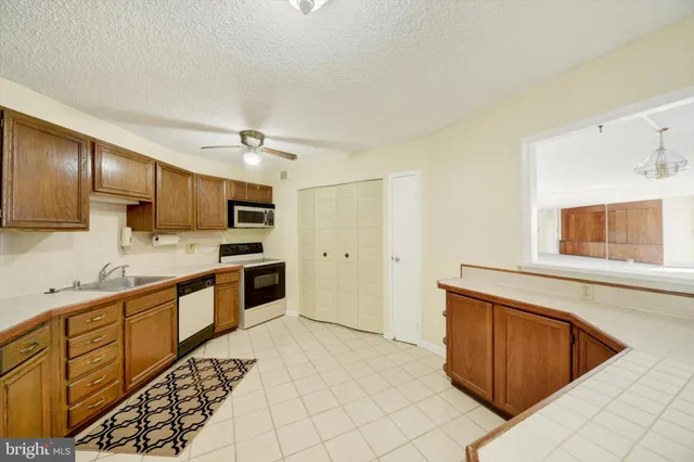 a open kitchen with stainless steel appliances granite countertop a sink and cabinets