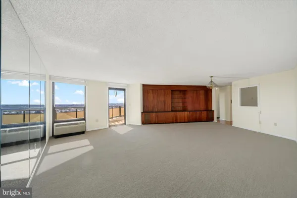 an empty room with furniture and a window