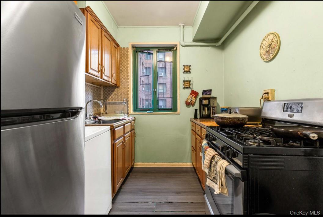1480 Parkchester Road Bronx, NY 10462 - Photo 4 of 5 a kitchen with stainless steel appliances granite countertop a stove and a refrigerator