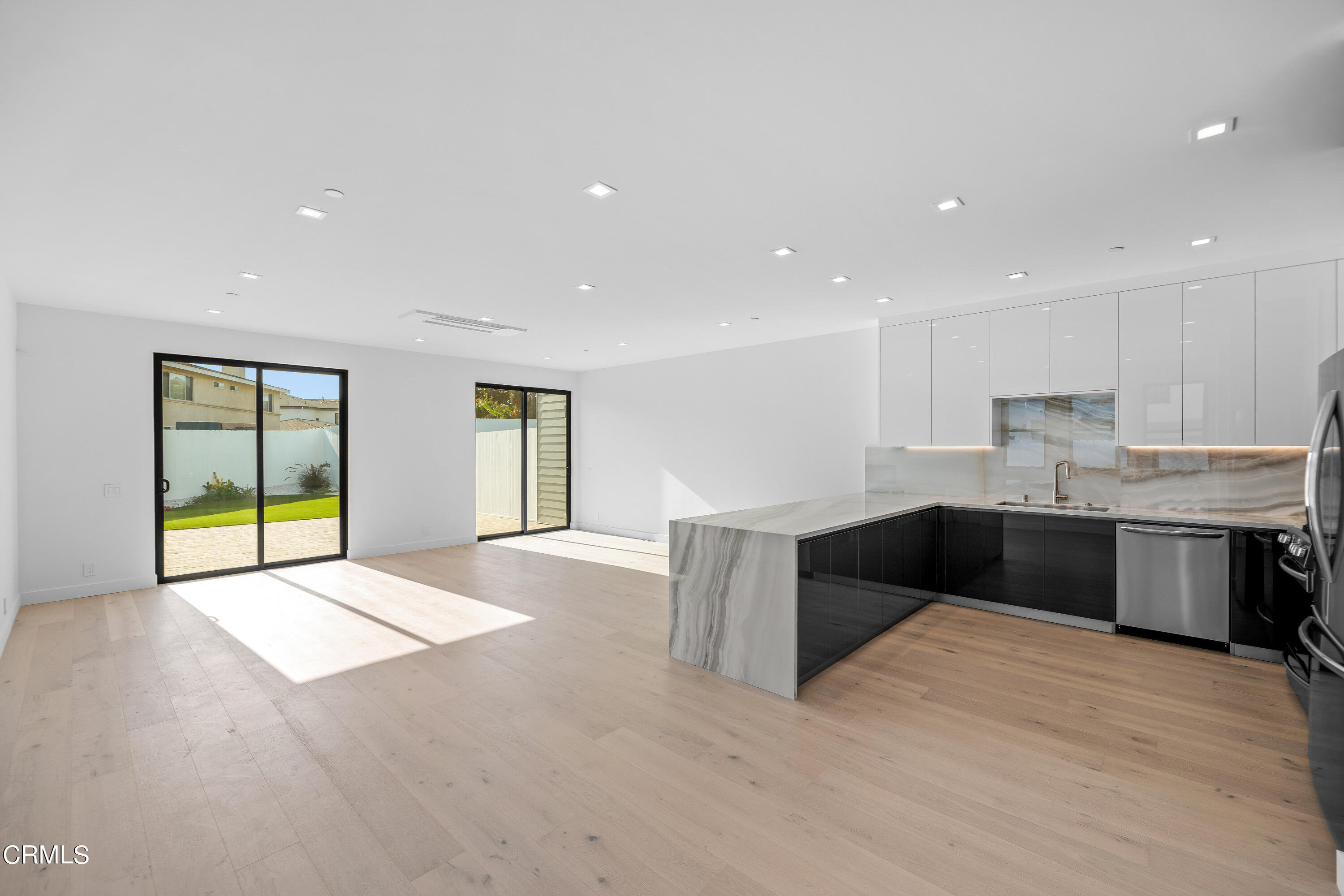 1005 Catamaran Street Oxnard, CA 93035 - Photo 13 of 35 a large kitchen with stainless steel appliances granite countertop a stove and a refrigerator