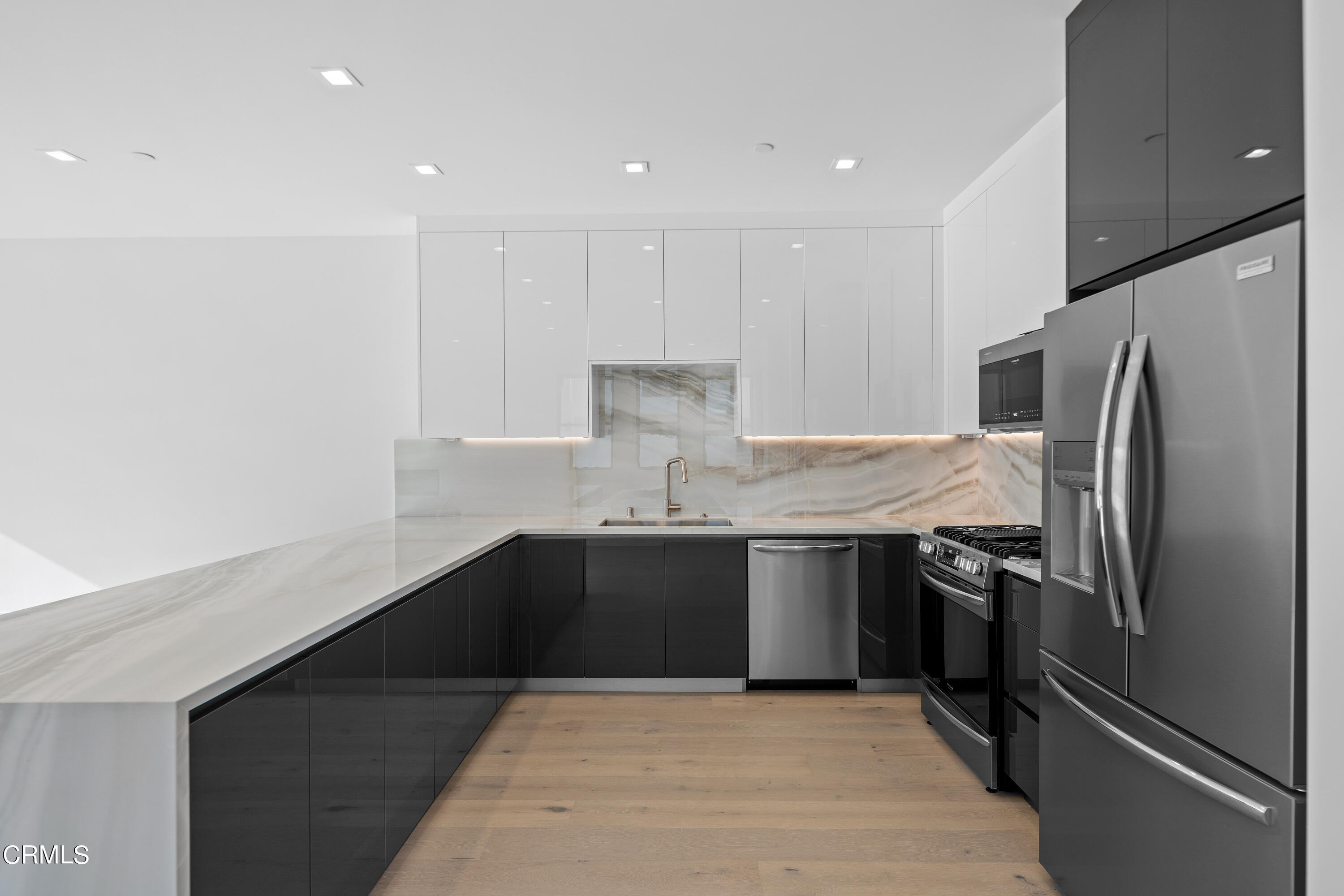 1005 Catamaran Street Oxnard, CA 93035 - Photo 14 of 35 a kitchen with a sink appliances and cabinets