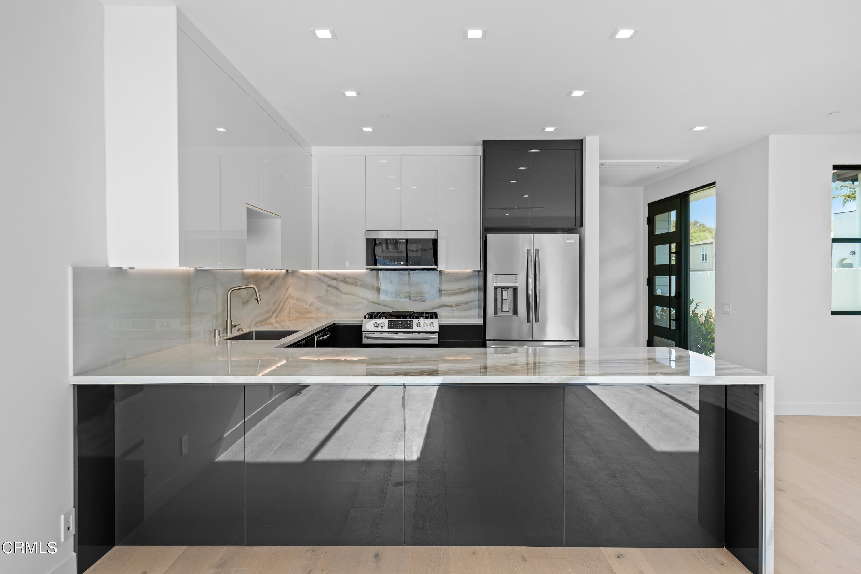 1005 Catamaran Street Oxnard, CA 93035 - Photo 16 of 35 a kitchen with stainless steel appliances granite countertop a stove a sink and a refrigerator