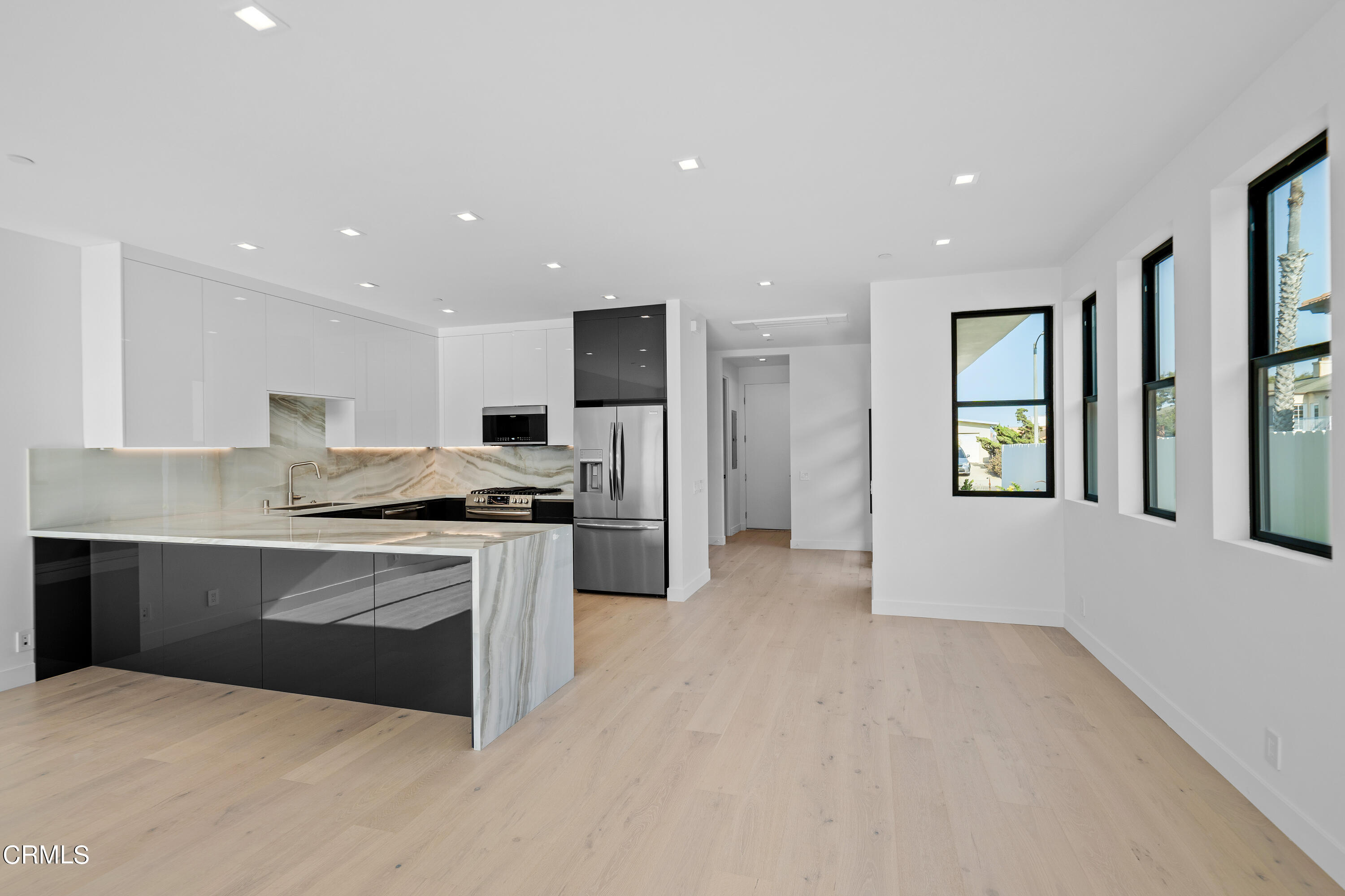 1005 Catamaran Street Oxnard, CA 93035 - Photo 18 of 35 a kitchen with stainless steel appliances granite countertop a stove and a refrigerator