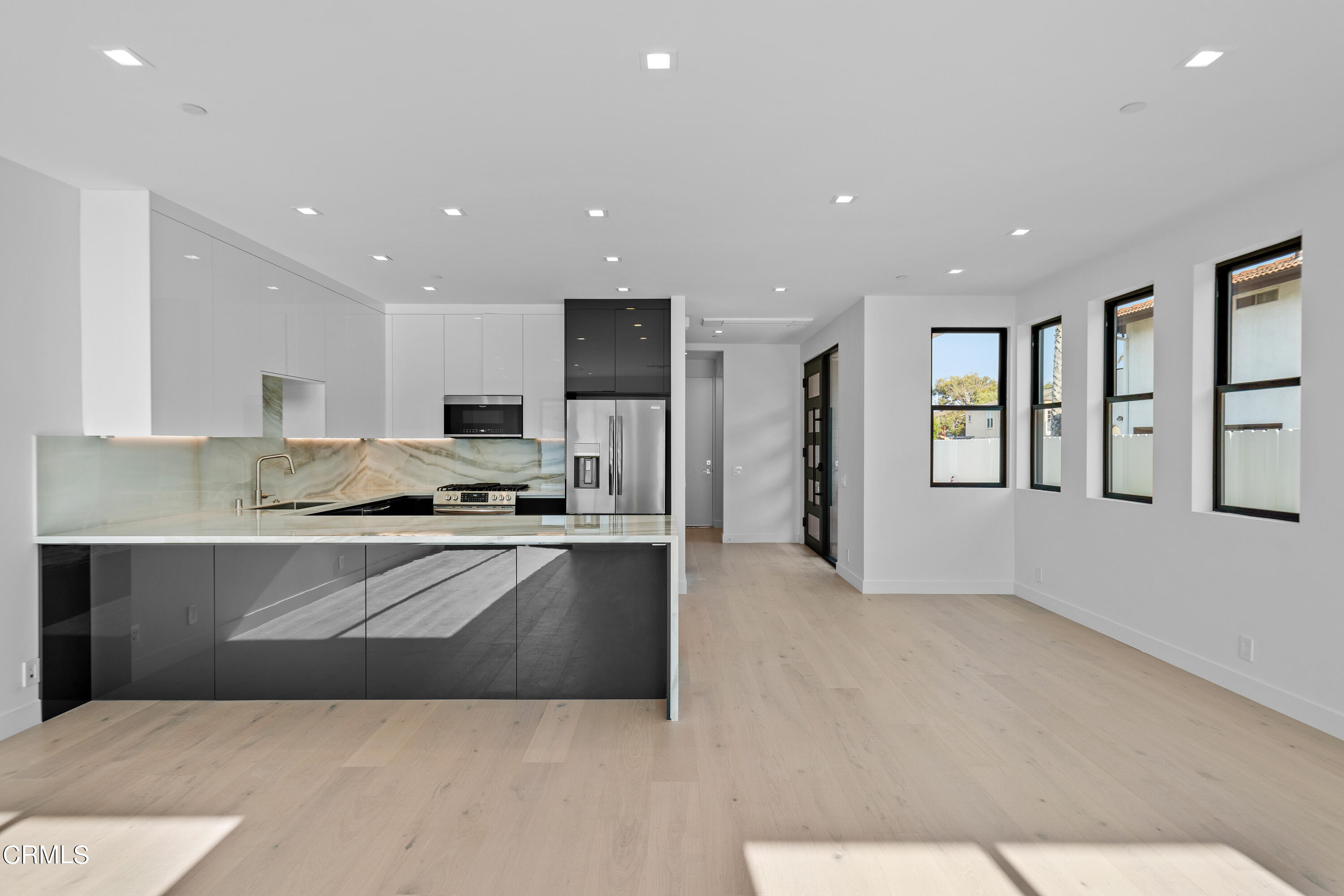 1005 Catamaran Street Oxnard, CA 93035 - Photo 19 of 35 a large kitchen with stainless steel appliances kitchen island granite countertop a refrigerator a stove and a sink