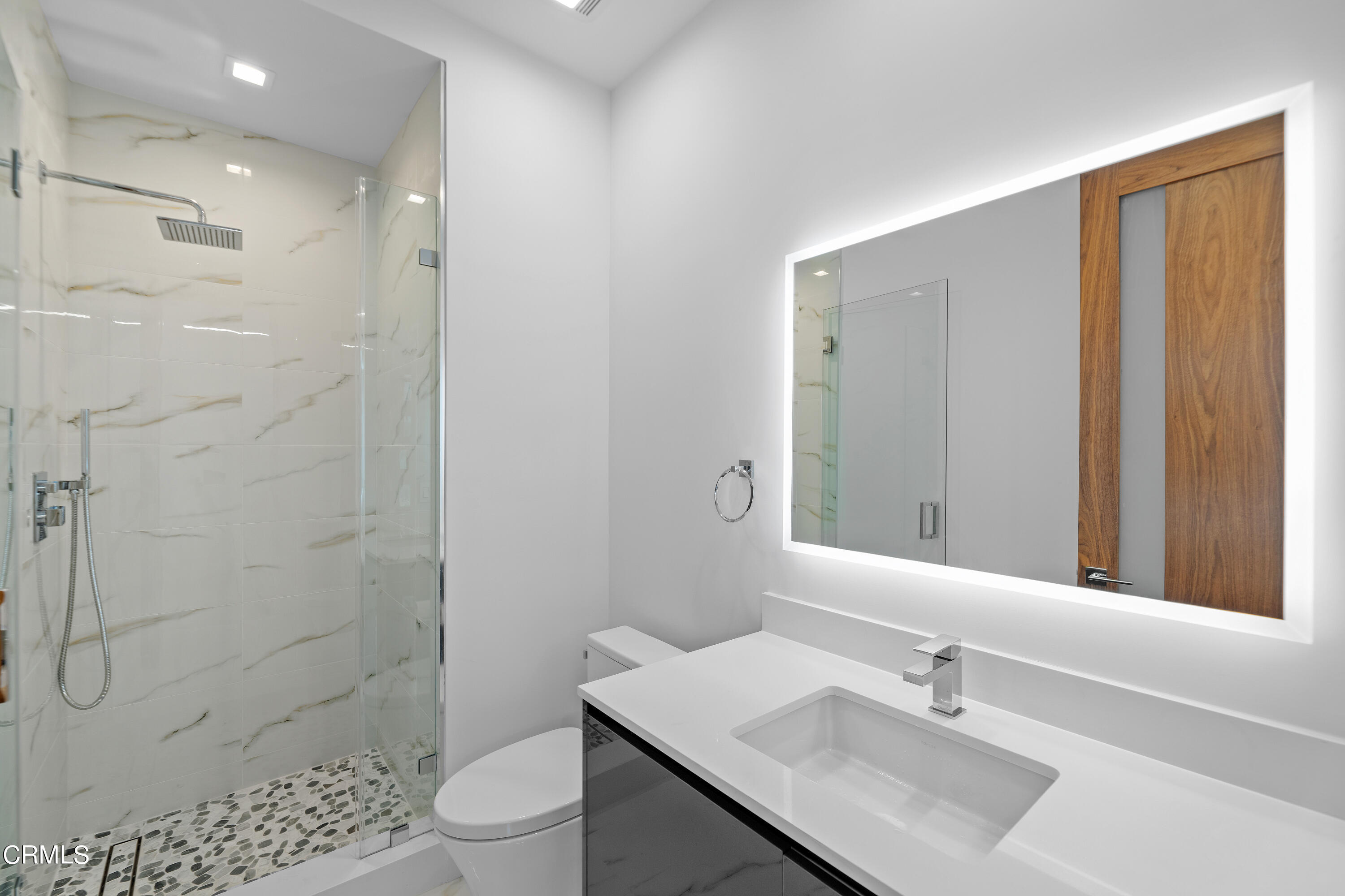 1005 Catamaran Street Oxnard, CA 93035 - Photo 22 of 35 a bathroom with a sink toilet a mirror and shower