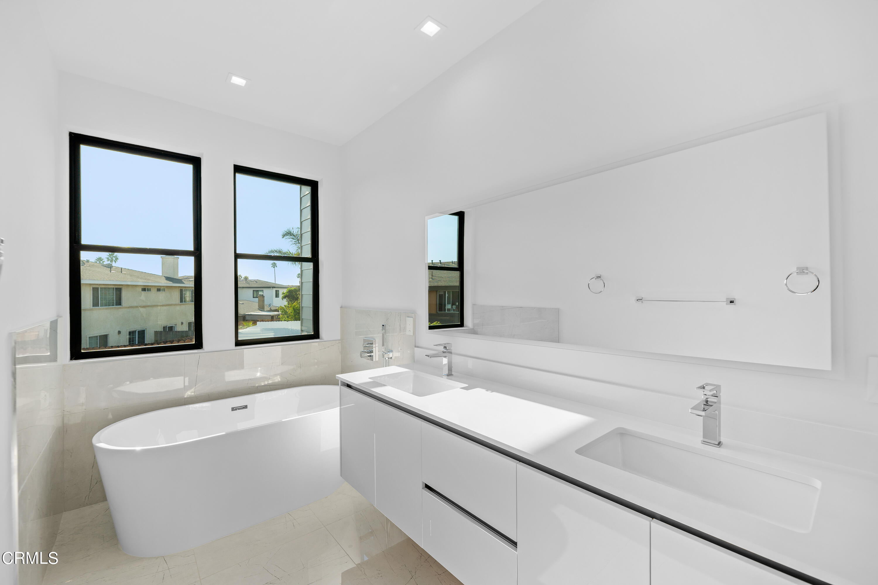 1005 Catamaran Street Oxnard, CA 93035 - Photo 31 of 35 a bathroom with a bathtub a sink and a window