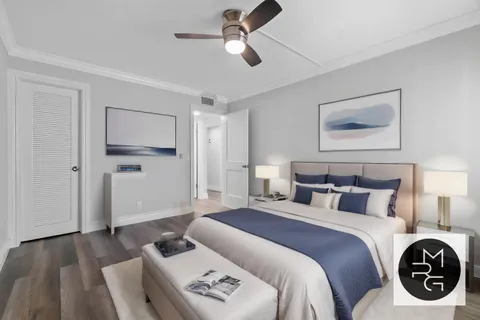 a bedroom with bed and ceiling fan