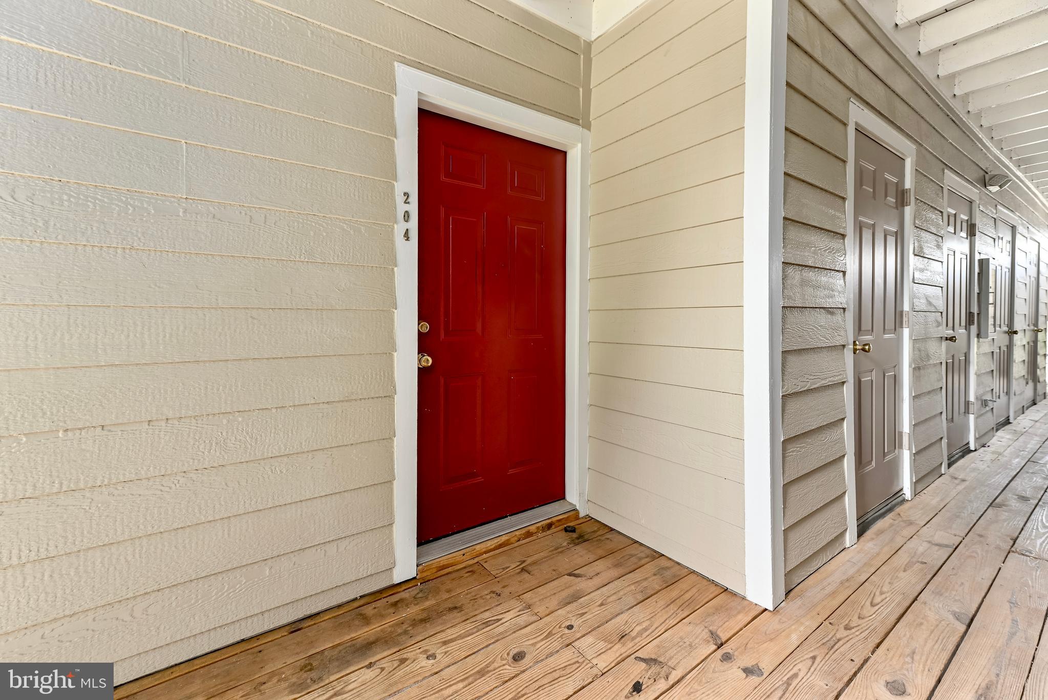 20991 Timber Ridge Terrace, Unit 204 Ashburn, VA 20147 - Photo 26 of 27 Front Door next to Storage Closet