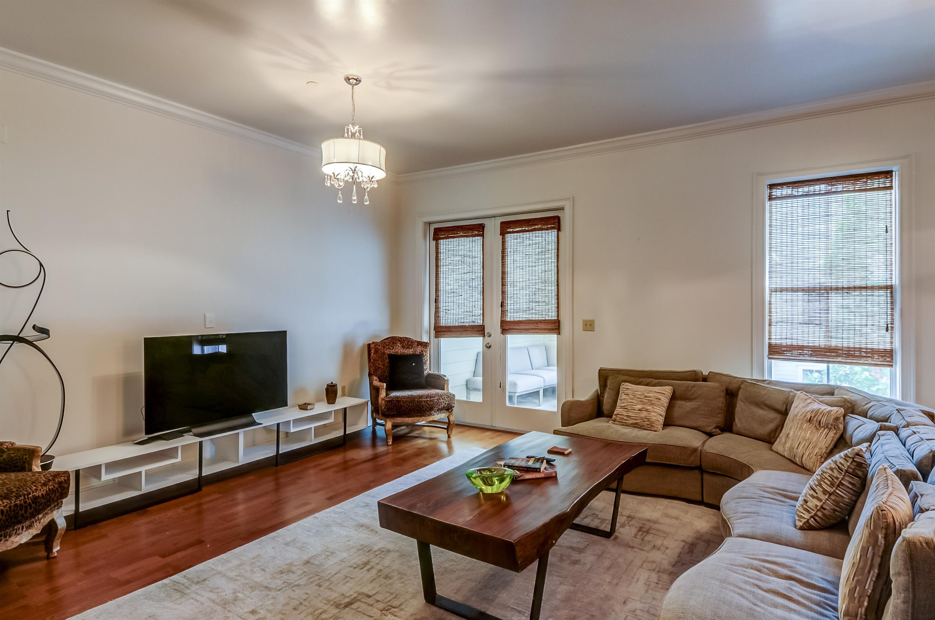 591 Lexington Road, Unit 303 Memphis, TN 38117 - Photo 29 of 34 a living room with furniture a rug and a flat screen tv
