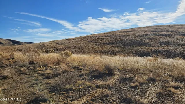 a view of a large mountain with mountains in the background