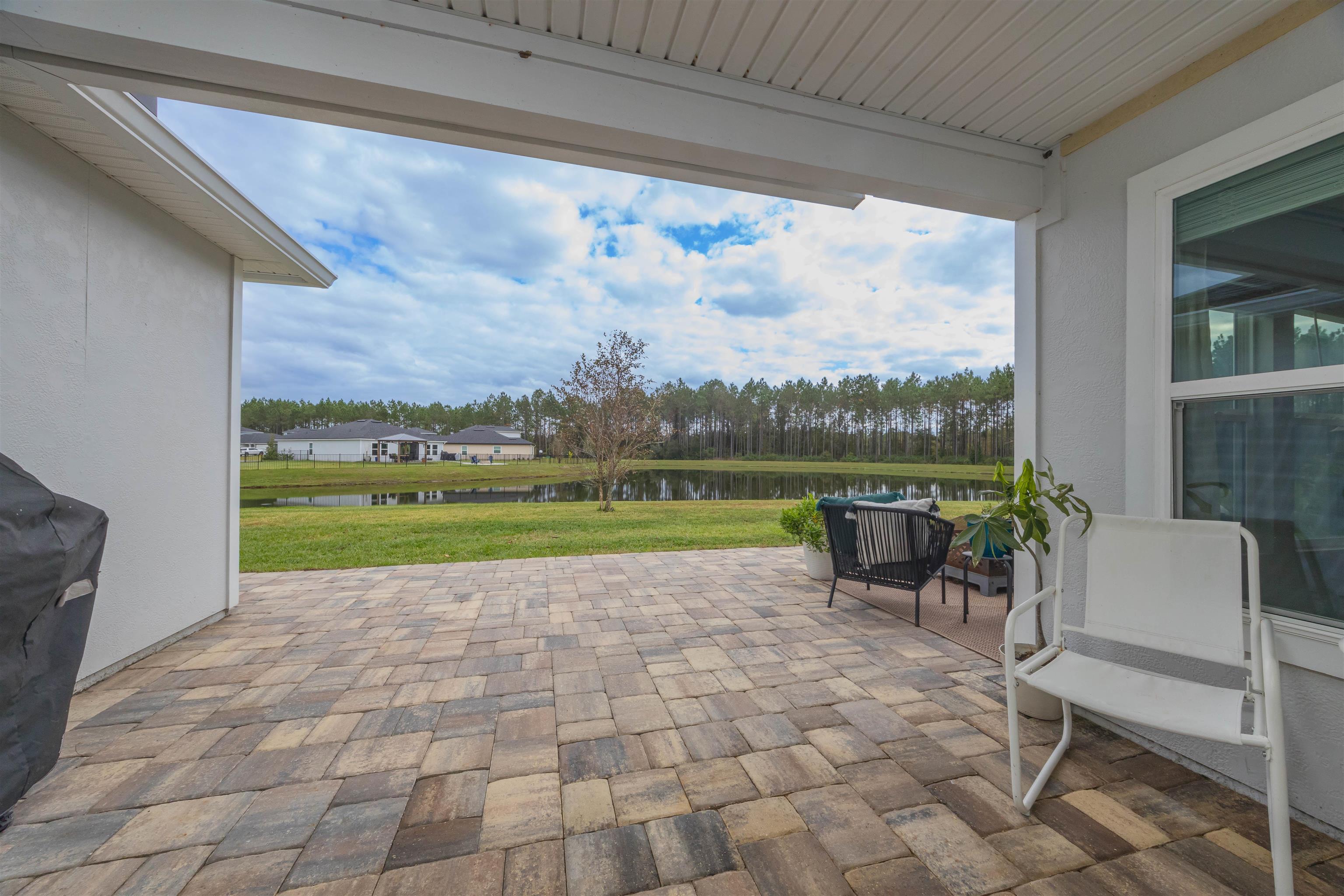 151 Birdfield Court St. Augustine, FL 32092 - Photo 25 of 73 a view of a chairs and table in patio with a yard