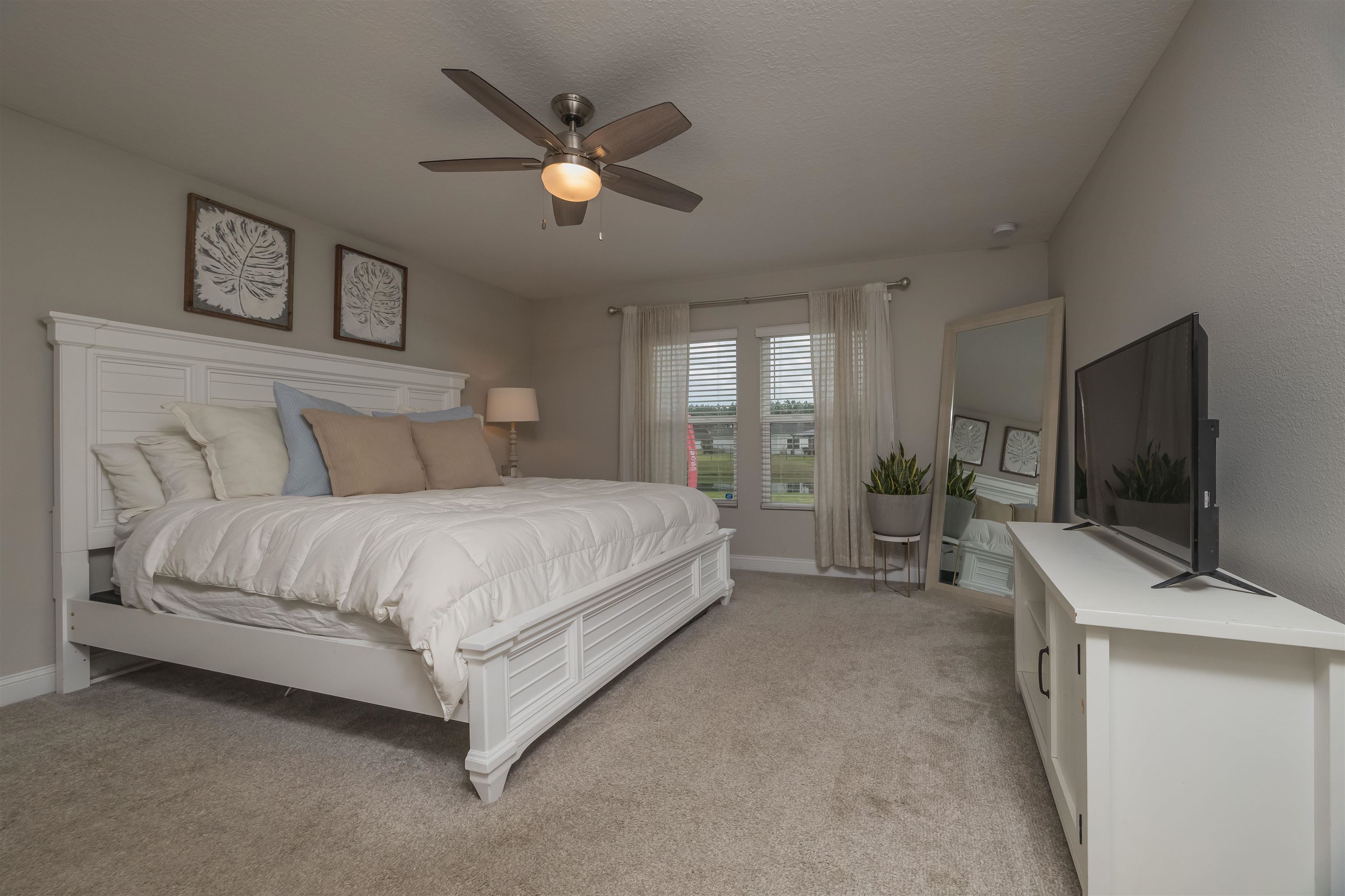 151 Birdfield Court St. Augustine, FL 32092 - Photo 33 of 73 a spacious bedroom with a bed and a flat screen tv