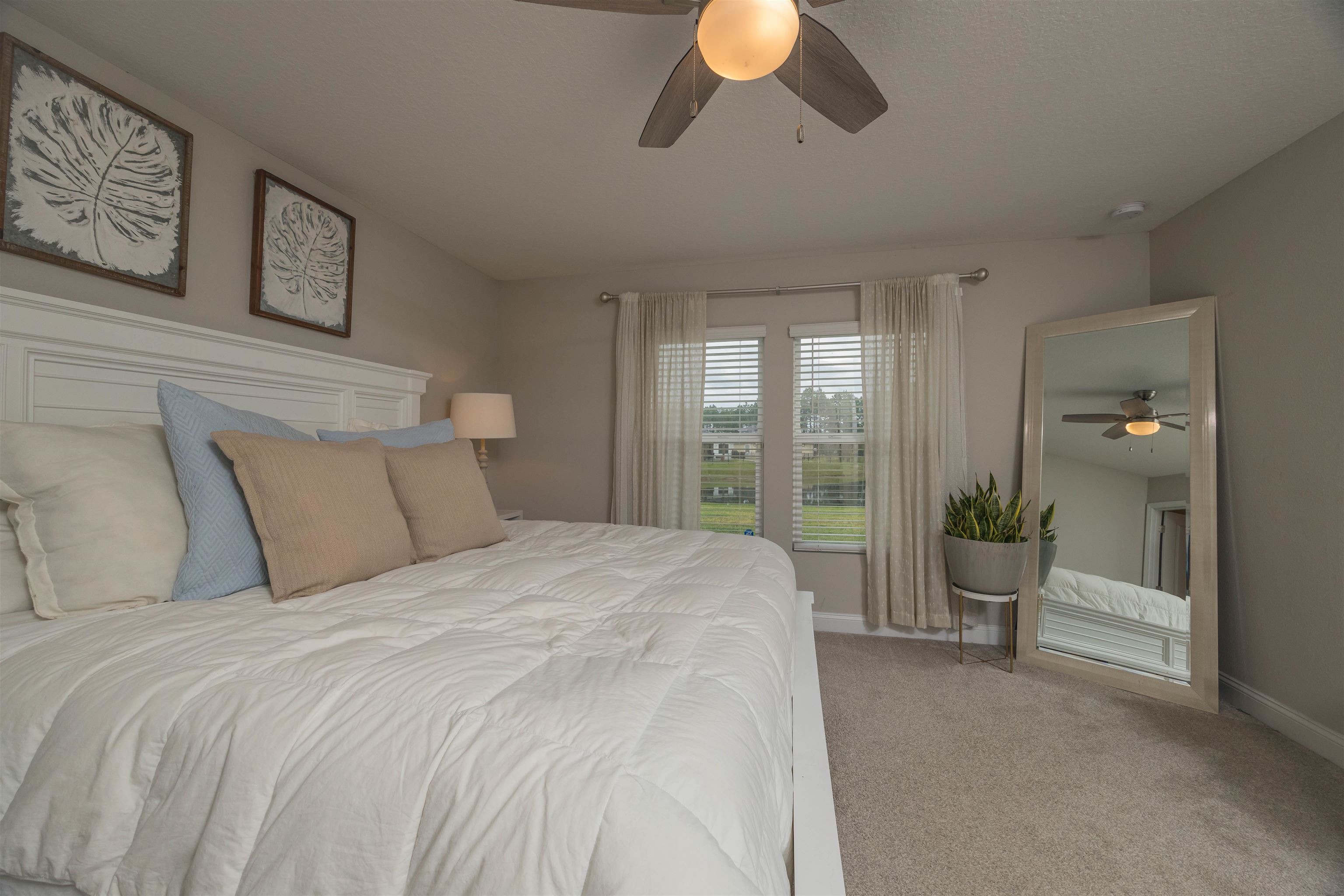 151 Birdfield Court St. Augustine, FL 32092 - Photo 35 of 73 a spacious bedroom with a bed and painting on the wall