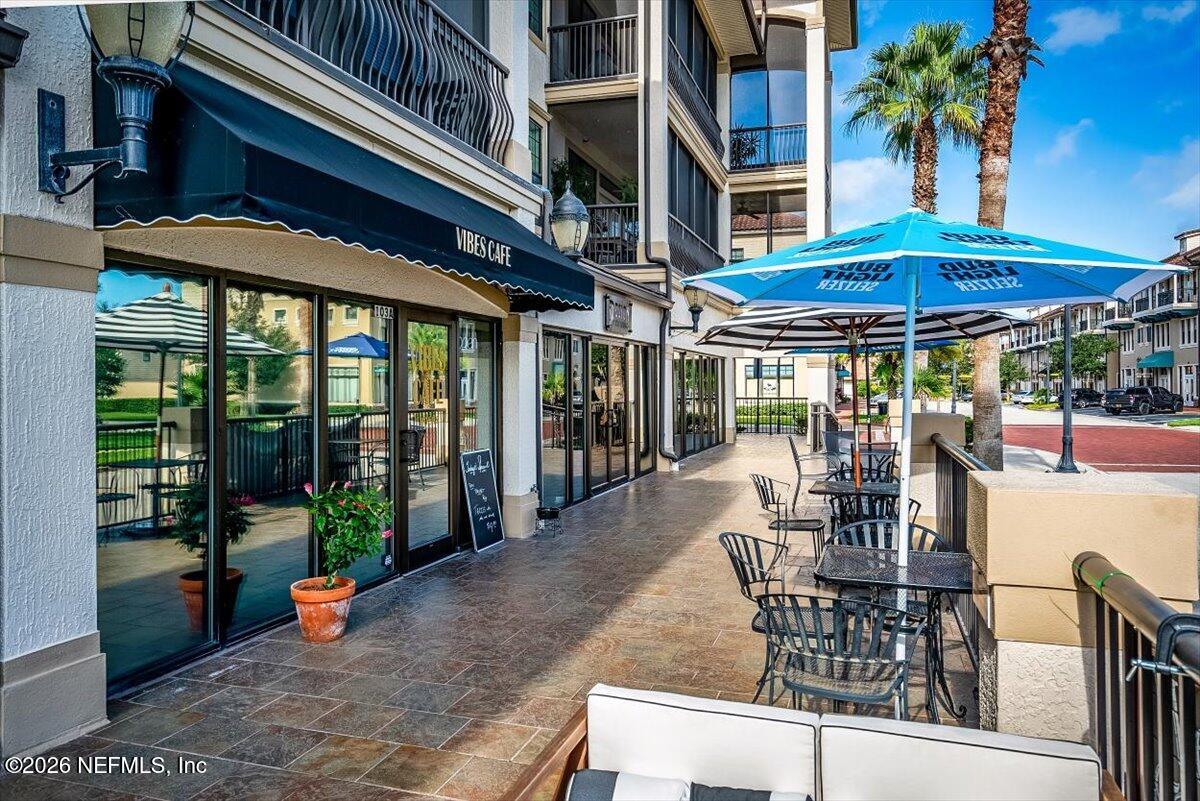 315 Via Castilla, Unit 204 St. Augustine, FL 32095 - Photo 15 of 18 a view of a patio with a table and chairs under an umbrella