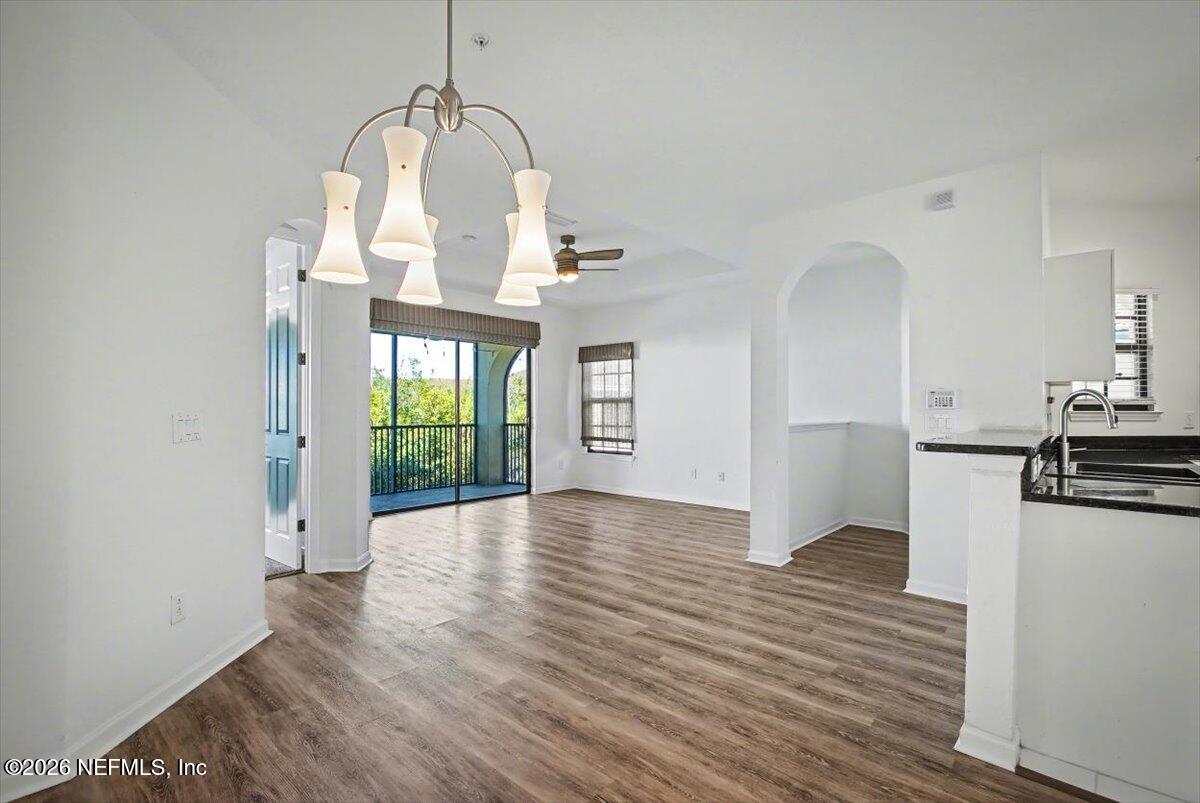 315 Via Castilla, Unit 204 St. Augustine, FL 32095 - Photo 4 of 18 a view of a living room with wooden floor kitchen view and a window