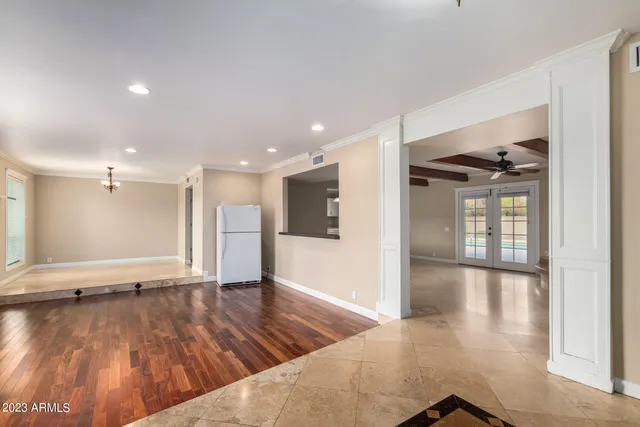 a view of a hallway with a chandelier and chandelier