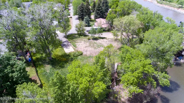 a backyard of a house with a yard and outdoor seating