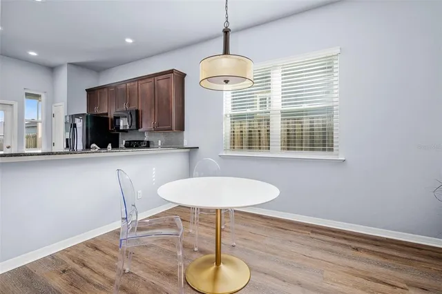a dining room with furniture and window