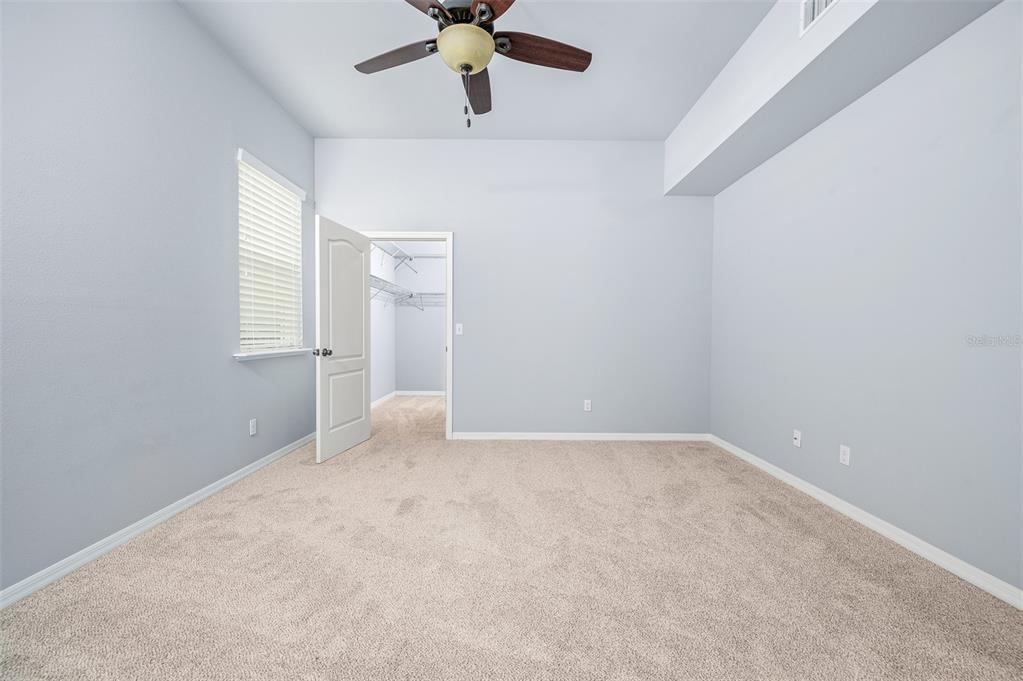 7891 Southwest 82nd Drive Gainesville, FL 32608 - Photo 15 of 38 an empty room with a chandelier fan and windows