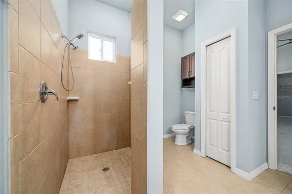 a bathroom with a granite countertop shower a toilet and a sink