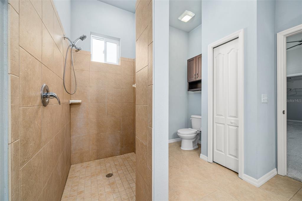 7891 Southwest 82nd Drive Gainesville, FL 32608 - Photo 20 of 38 a bathroom with a granite countertop shower a toilet and a sink