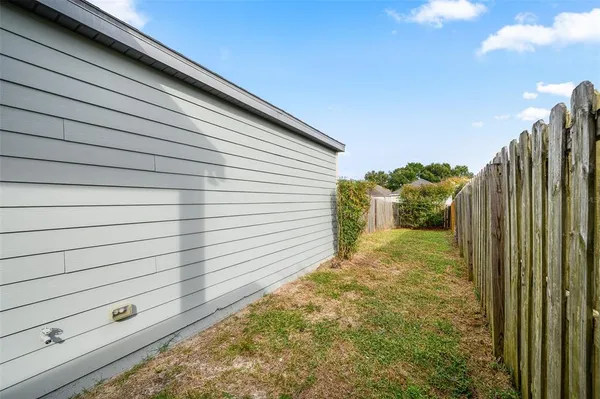 a view of a house with backyard and garden