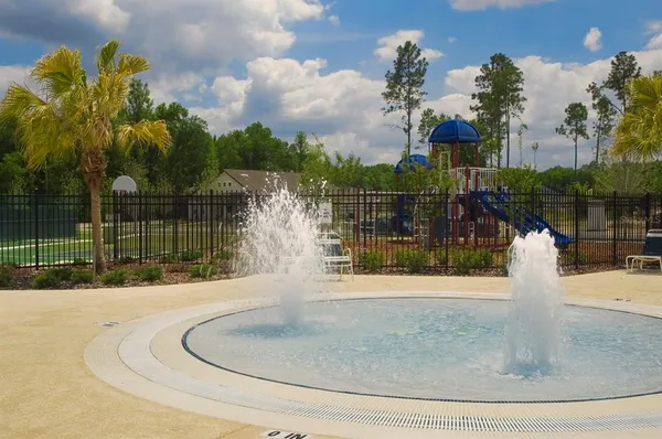 a living room with fireplace furniture and a large window