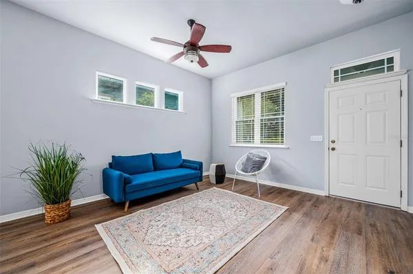 a living room with furniture and wooden floor