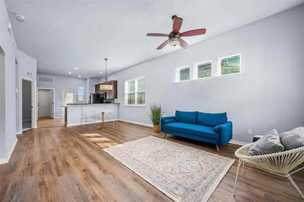 a living room with furniture and a wooden floor