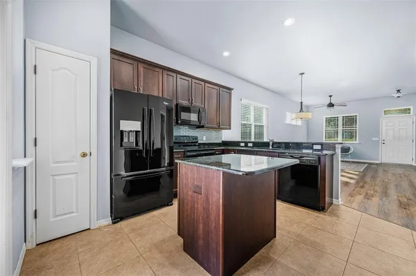 a kitchen with stainless steel appliances granite countertop a refrigerator and a sink