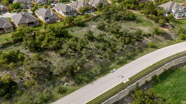 an aerial view of a houses with a yard