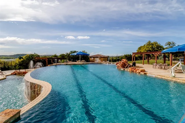 a view of a swimming pool with an outdoor seating and a garden