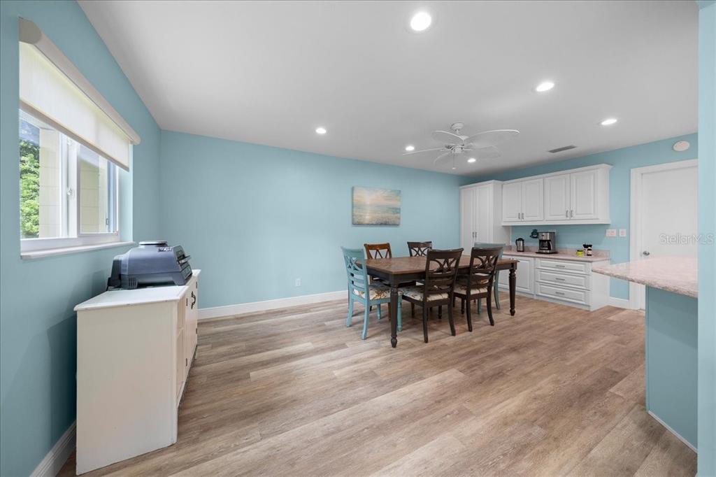 8720 Southwest 90th Street, Unit A Ocala, FL 34481 - Photo 18 of 71 a view of a dining area with furniture window and wooden floor