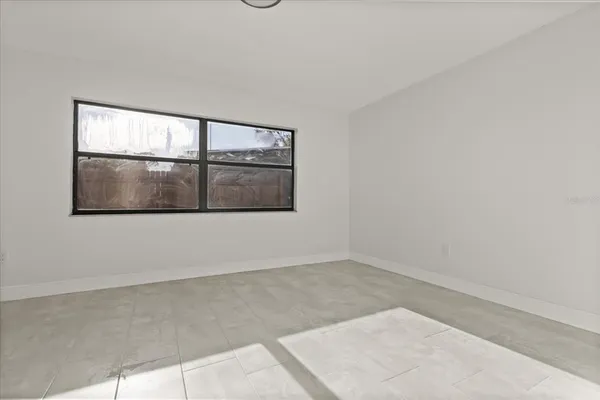 a view of a room that has a bed and window