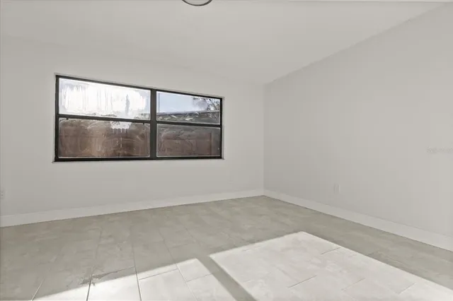 a view of a room that has a bed and window