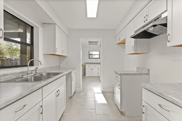 a kitchen with stainless steel appliances granite countertop a sink and a stove