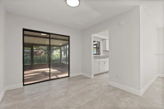 a view of an empty room with glass door