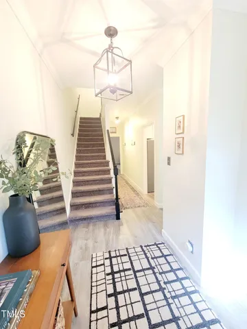 a view of entryway and hall with wooden floor