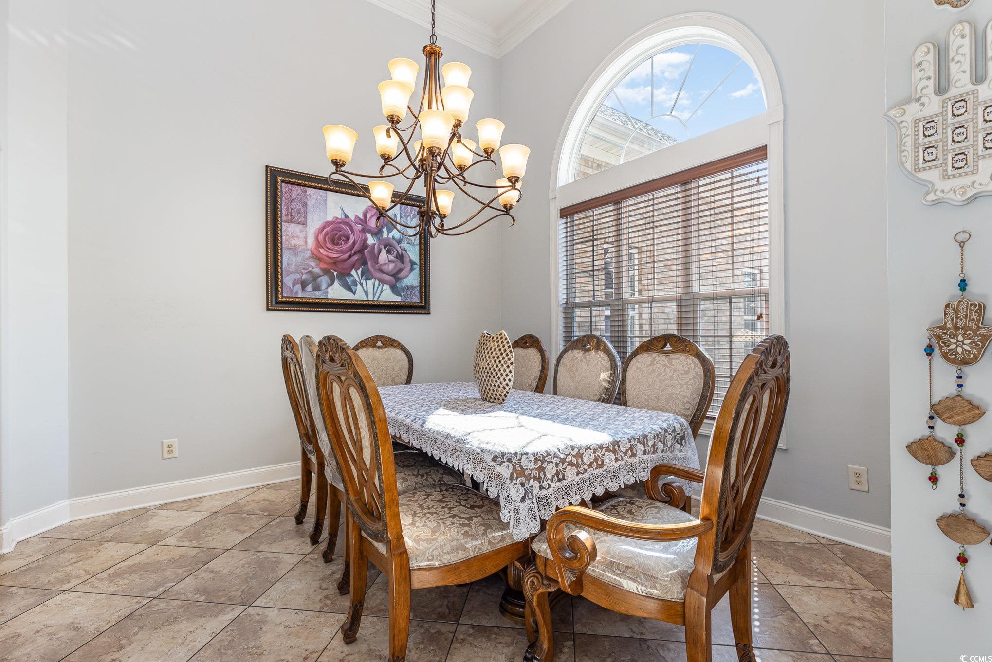 1069 Cole Court Myrtle Beach, SC 29577 - Photo 12 of 40 Dining space with crown molding, a chandelier, and light tile patterned floors