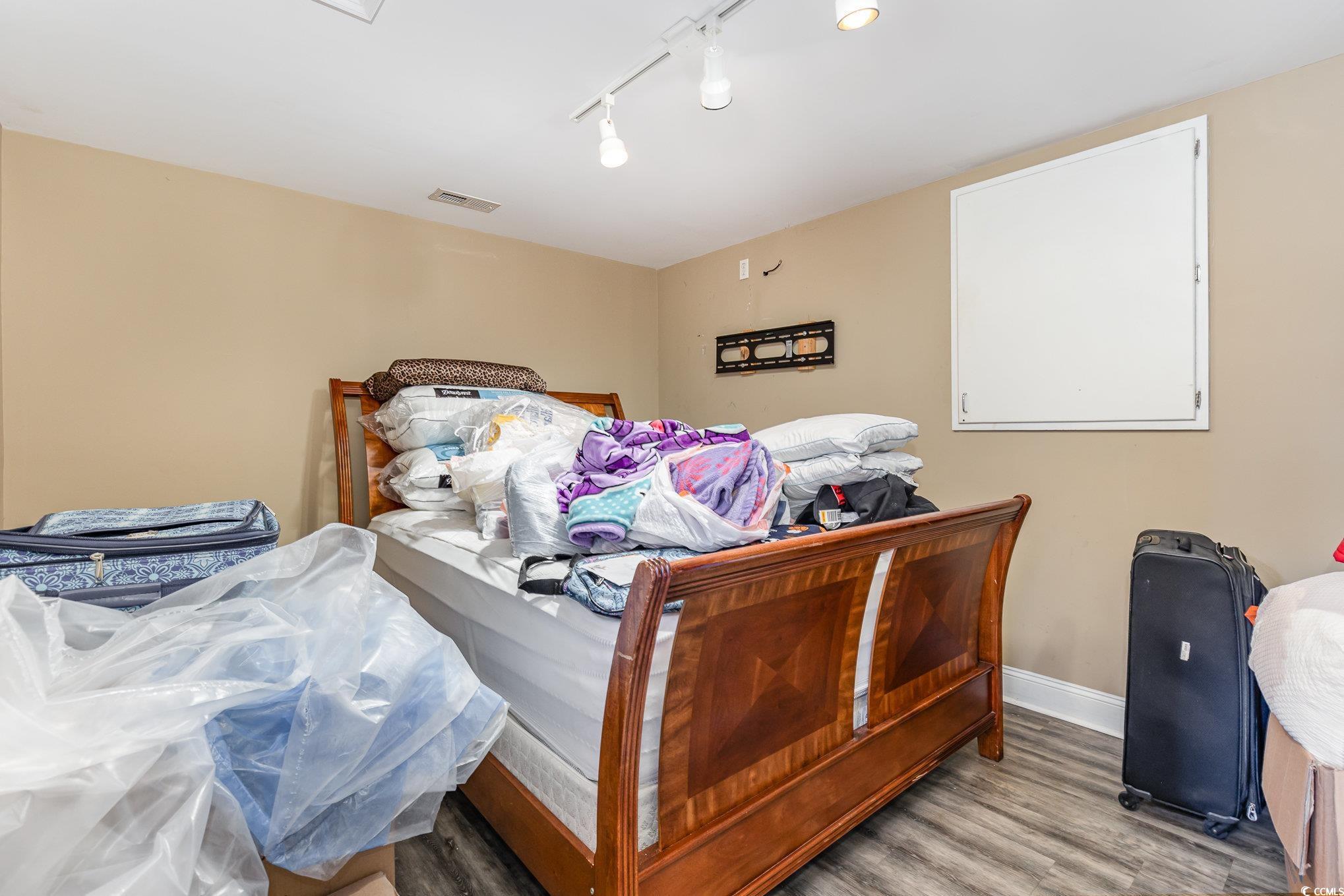 1069 Cole Court Myrtle Beach, SC 29577 - Photo 27 of 40 Bedroom featuring rail lighting and wood finished floors