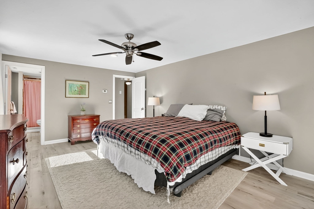 37 Captain Road Longmeadow, MA 01106 - Photo 23 of 42 a bedroom with a bed and a chandelier