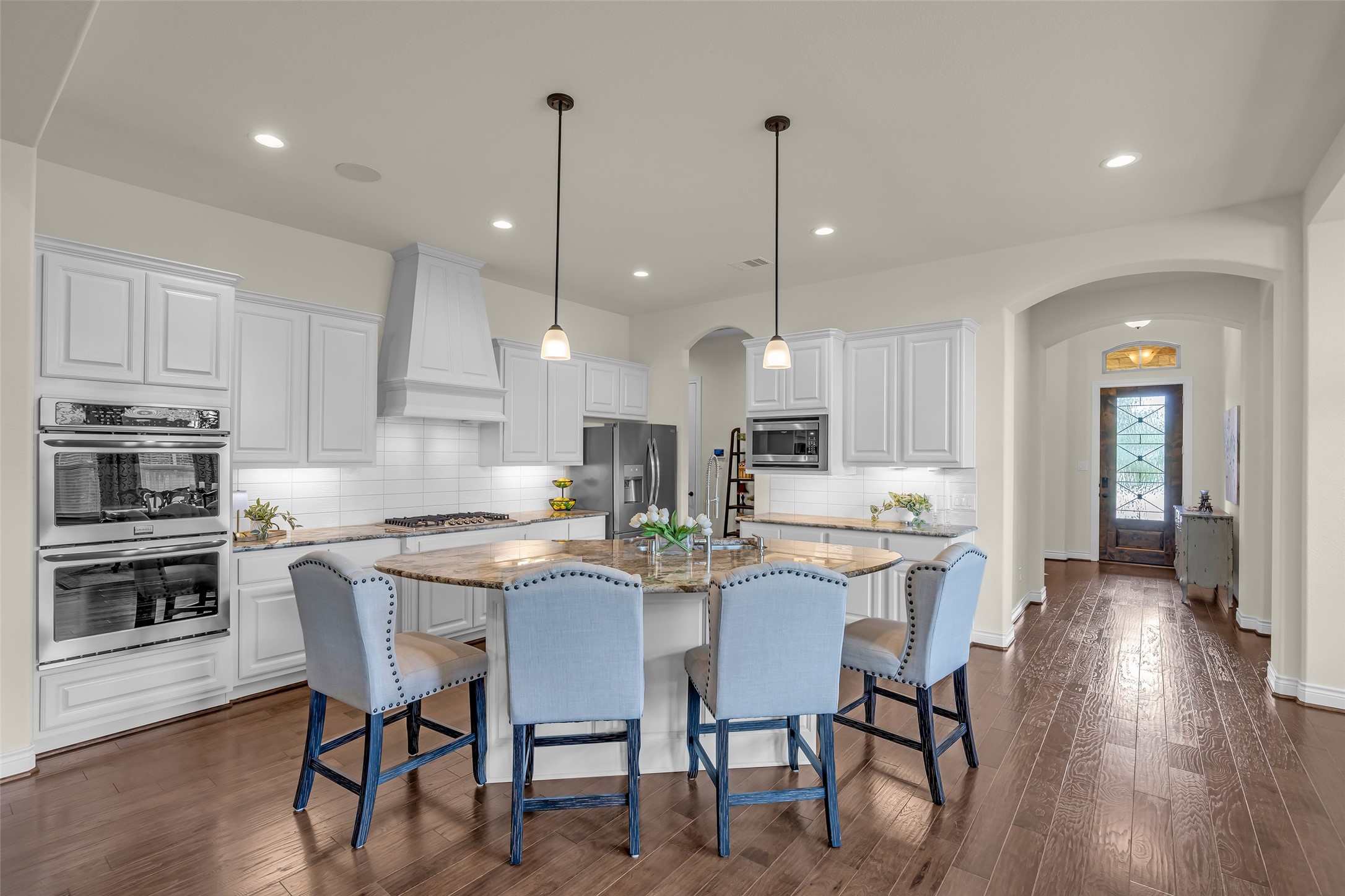 14003 South Evergreen Ridge Court Conroe, TX 77384 - Photo 11 of 43 Striking island kitchen with exotic granite countertops, double ovens, gas cooktop, abundant cabinetry, and generous seating.