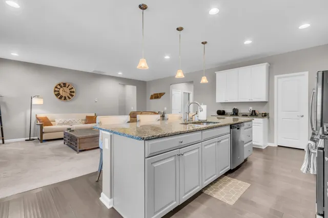 a kitchen with a sink dishwasher and a refrigerator